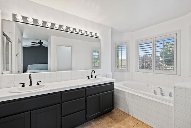 bathroom with vanity, shower with separate bathtub, ceiling fan, and tile patterned floors