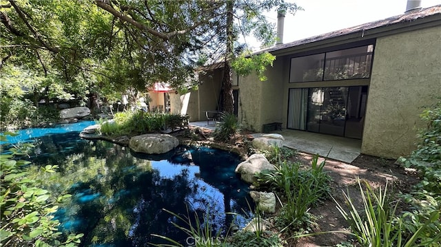 view of yard featuring a swimming pool and a patio area