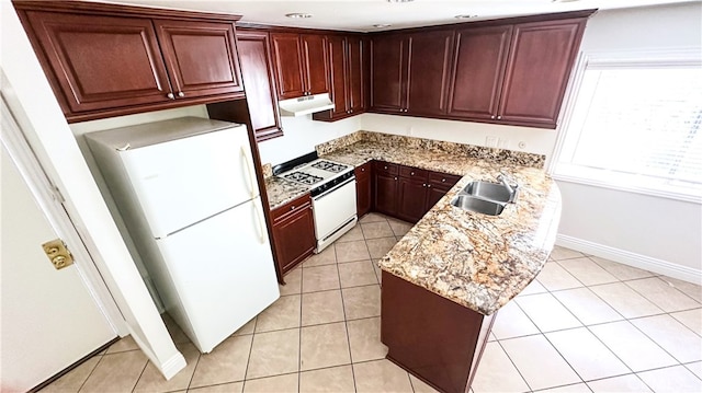 kitchen with light stone countertops, white appliances, sink, and light tile patterned floors