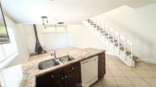 kitchen with dark brown cabinets, dishwasher, sink, and light stone counters