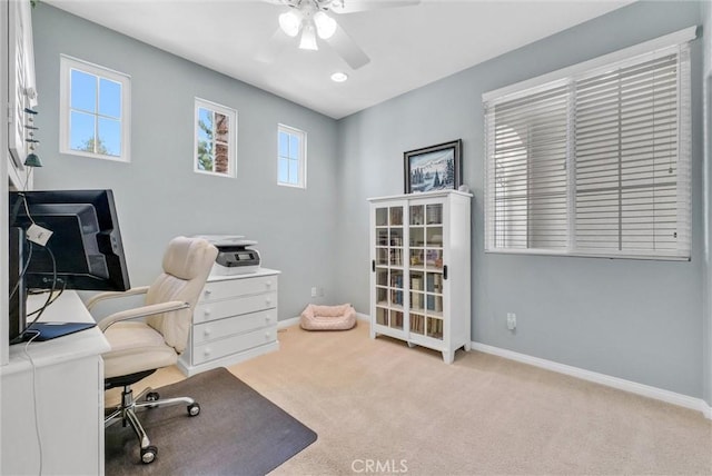 office space with light carpet and ceiling fan