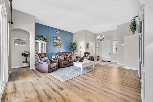 living room featuring light hardwood / wood-style flooring and a notable chandelier