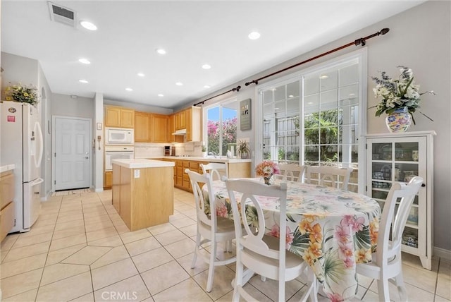 dining area with light tile patterned flooring