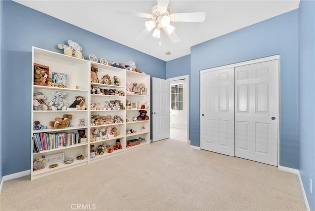 playroom with light carpet and ceiling fan