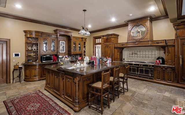 kitchen featuring dark brown cabinetry, hanging light fixtures, a kitchen island, stainless steel appliances, and crown molding