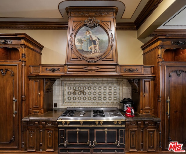 kitchen featuring double oven range, backsplash, and crown molding