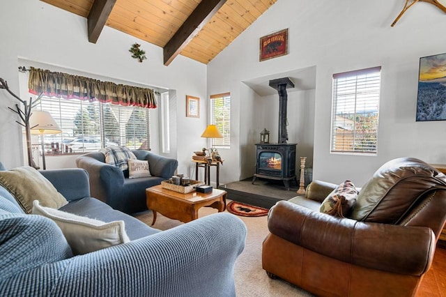 living room featuring hardwood / wood-style floors, beam ceiling, high vaulted ceiling, wooden ceiling, and a wood stove