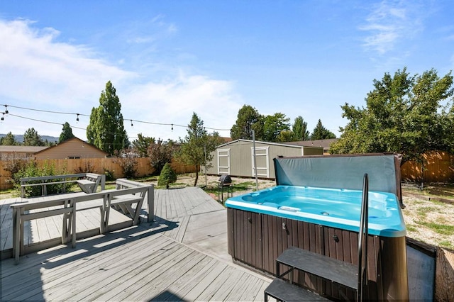 wooden deck featuring a hot tub and a storage unit