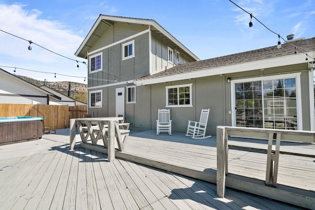 deck featuring a hot tub