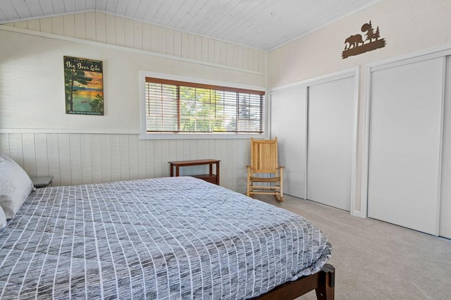 bedroom with wood ceiling, carpet flooring, vaulted ceiling, and wooden walls