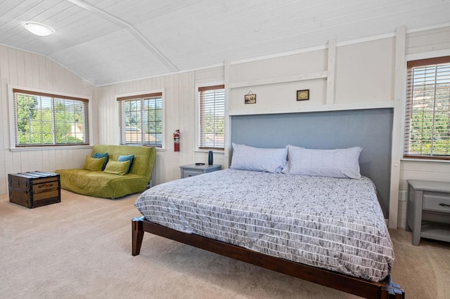 bedroom with multiple windows, carpet flooring, and vaulted ceiling