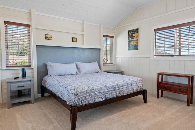 bedroom featuring lofted ceiling, wooden walls, light carpet, and wood ceiling