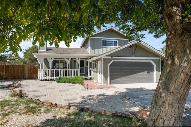 view of property featuring covered porch and a garage