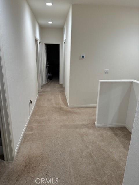 corridor with light colored carpet