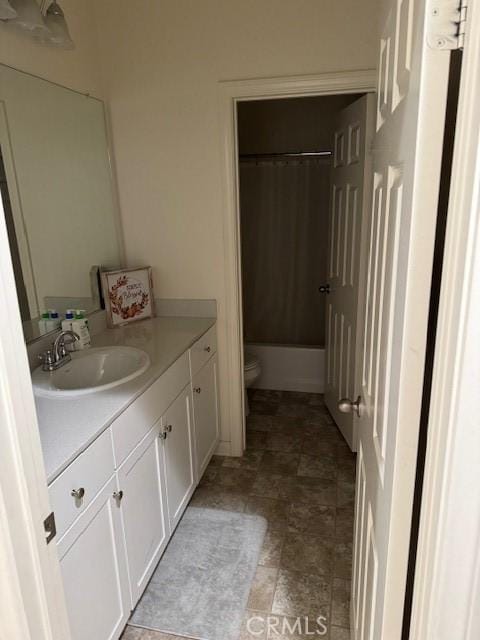 full bathroom featuring vanity, toilet, and shower / bath combination with curtain