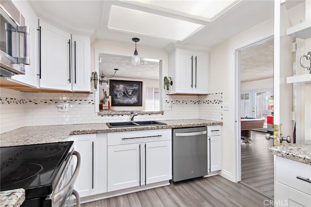 kitchen featuring white cabinetry, sink, stainless steel appliances, and billiards