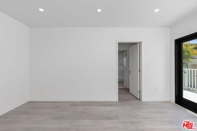 unfurnished room with light wood-type flooring