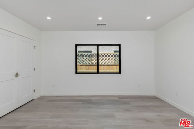 spare room featuring light hardwood / wood-style flooring