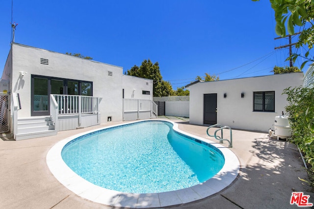 view of swimming pool with a patio area