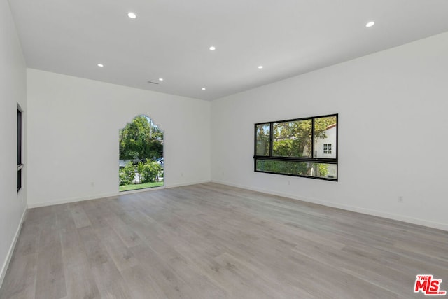 unfurnished room with light wood-type flooring