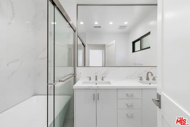 bathroom featuring vanity and a tub to relax in