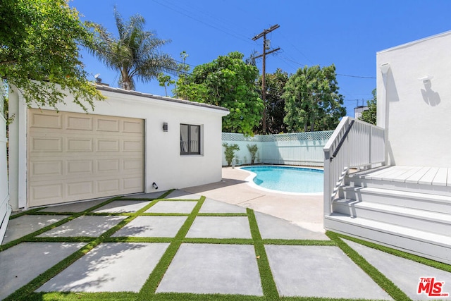 view of swimming pool with a patio area