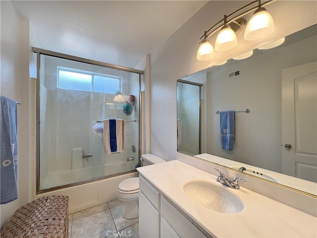 full bathroom featuring vanity, toilet, tile patterned floors, and enclosed tub / shower combo