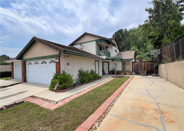 view of front of house featuring a balcony, a front yard, and a garage