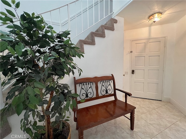 stairway featuring tile patterned flooring