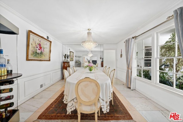 dining room featuring a notable chandelier and ornamental molding