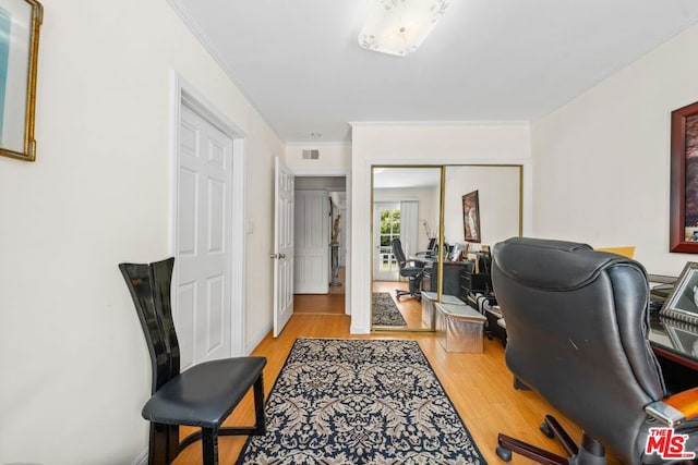 office featuring light wood-type flooring and crown molding