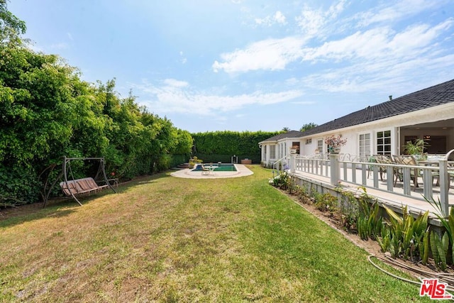 view of yard with a swimming pool side deck