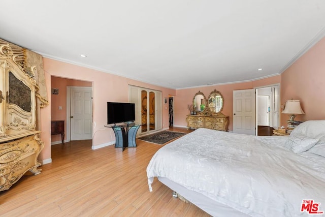 bedroom with wood-type flooring and crown molding