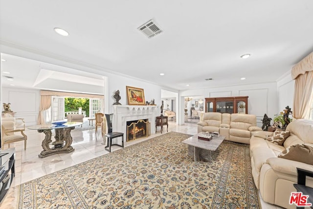 living room featuring light tile patterned floors and ornamental molding