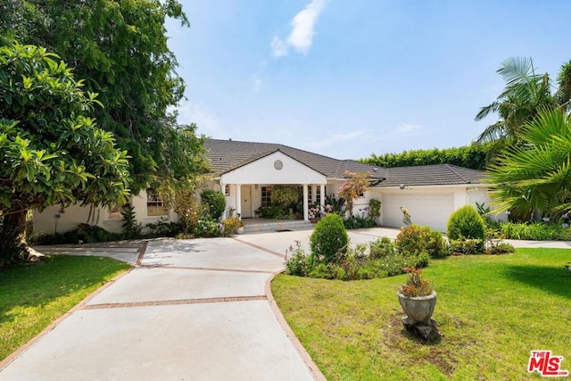 single story home featuring a front lawn and a garage