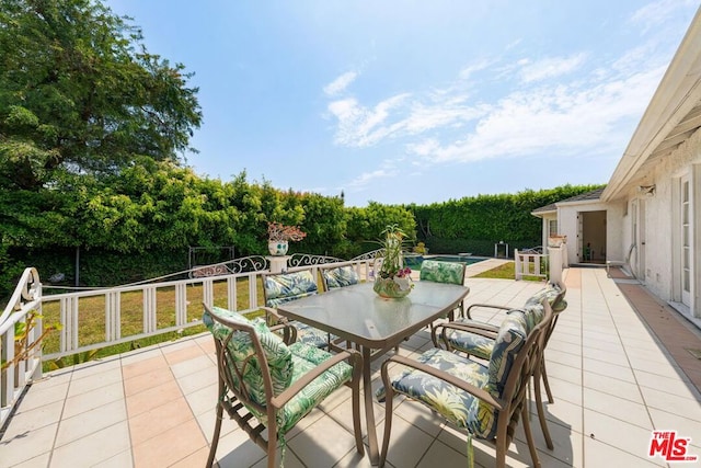 view of patio / terrace featuring a pool