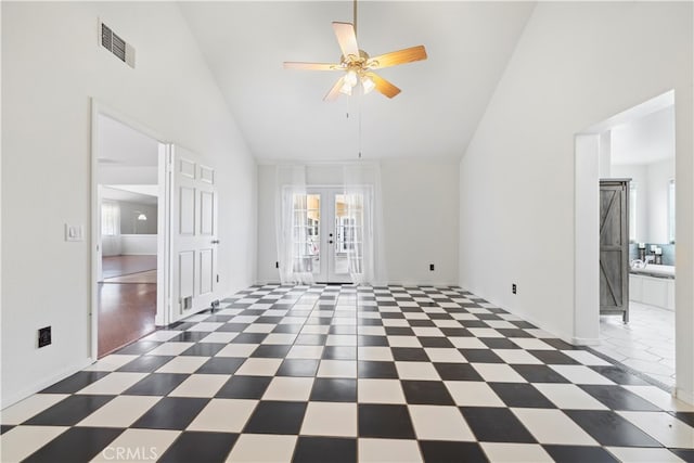 spare room featuring ceiling fan, dark wood-type flooring, french doors, and high vaulted ceiling