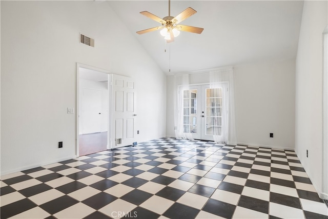 spare room featuring high vaulted ceiling, ceiling fan, and french doors