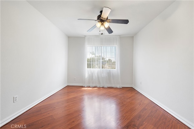 spare room with ceiling fan and hardwood / wood-style flooring