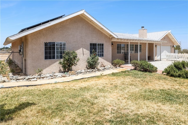 view of front of home with a front yard and a garage