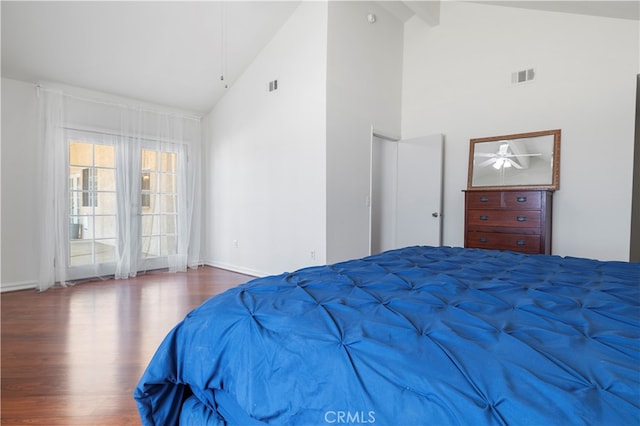 bedroom with wood-type flooring, beamed ceiling, and high vaulted ceiling