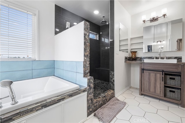 bathroom featuring vanity and shower with separate bathtub