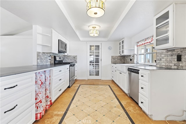 kitchen featuring stainless steel appliances, tasteful backsplash, and white cabinetry