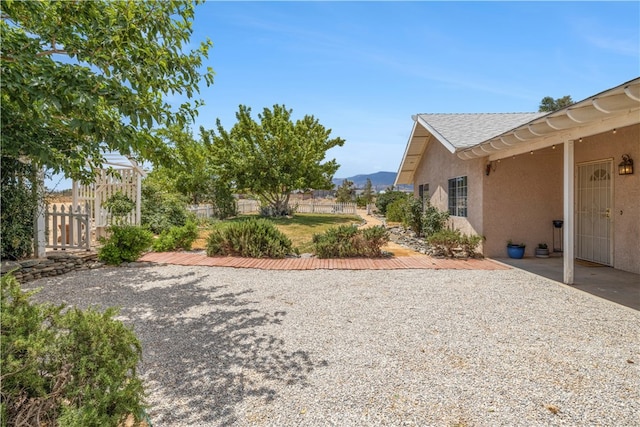 view of yard featuring a mountain view and a patio area