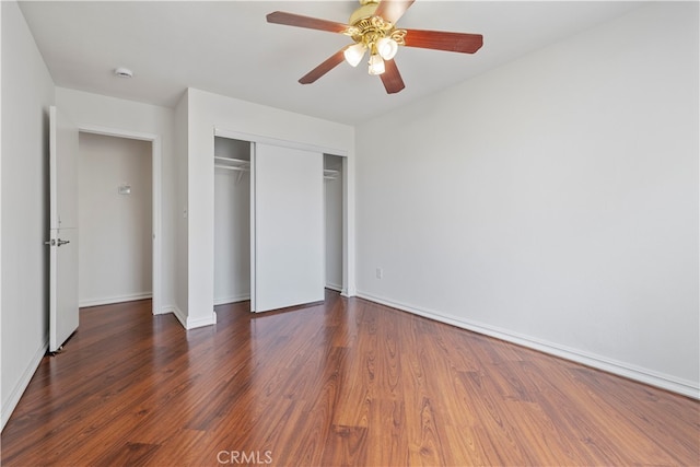 unfurnished bedroom featuring a closet, ceiling fan, and dark wood-type flooring