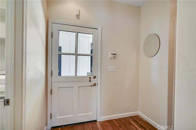 doorway to outside featuring dark wood-type flooring