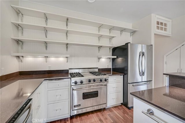 kitchen featuring white cabinetry, dark hardwood / wood-style flooring, and appliances with stainless steel finishes