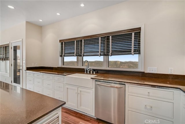 kitchen featuring white cabinetry, dishwasher, sink, and light hardwood / wood-style flooring