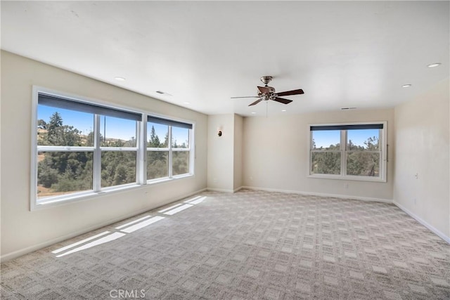 spare room featuring a ceiling fan, baseboards, light colored carpet, and recessed lighting