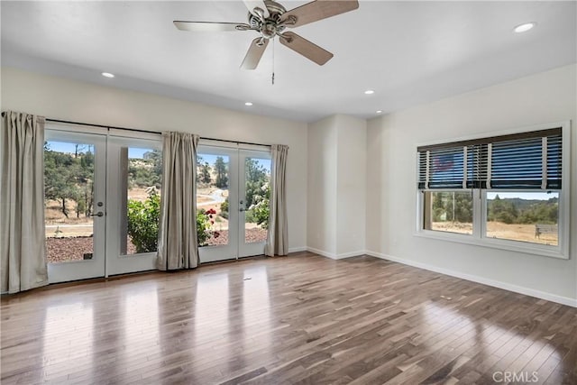 unfurnished room featuring french doors, ceiling fan, and hardwood / wood-style floors